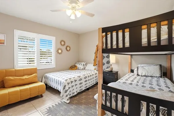 a bedroom with two beds and a large window