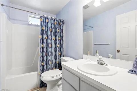 a dining room with stainless steel appliances granite countertop furniture and a large window