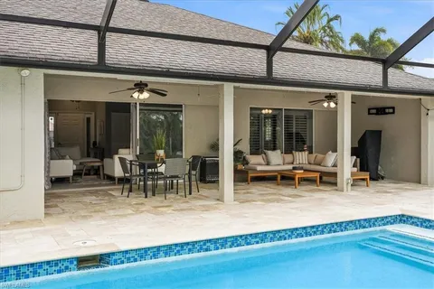 a view of a backyard with swimming pool