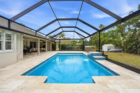 a view of swimming pool with seating space