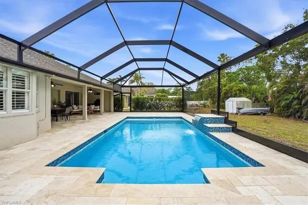 a view of swimming pool with seating space