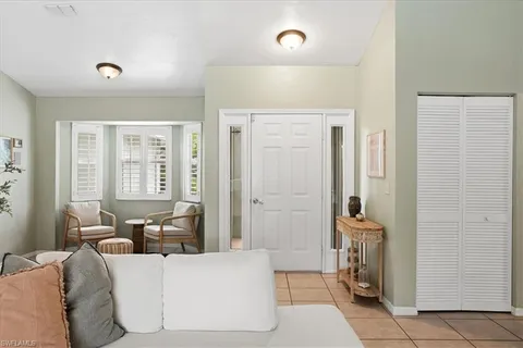 a living room with furniture and large windows