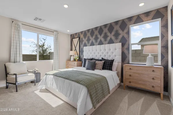 a bedroom with a bed and large window