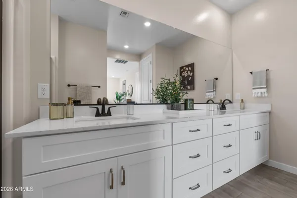 a bathroom with a double vanity sink and mirror