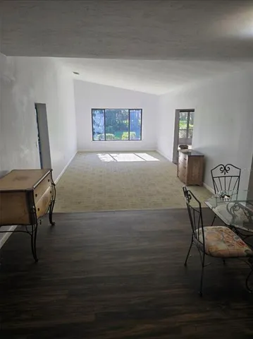 a bedroom with a bed window and chair