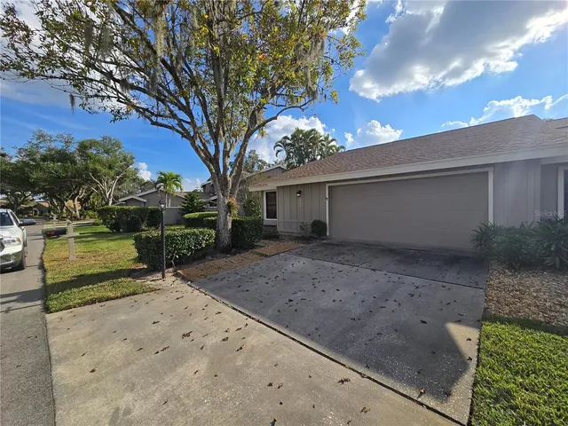 a view of a house with backyard and trees