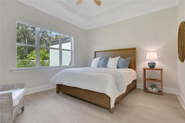 a bed sitting in a bedroom next to a window