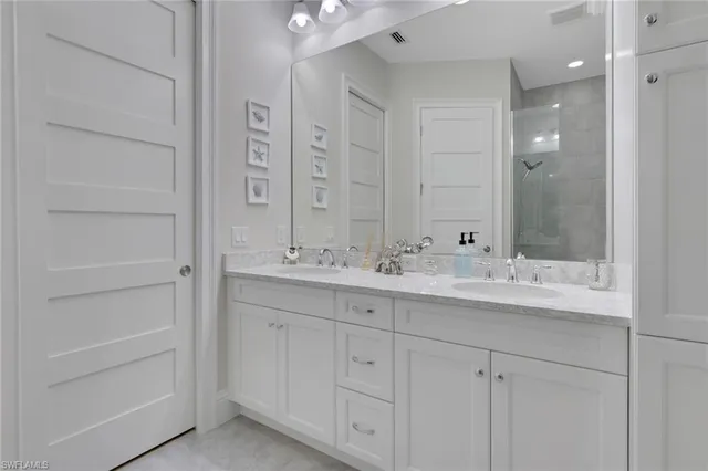 a bathroom with a double vanity sink and a mirror