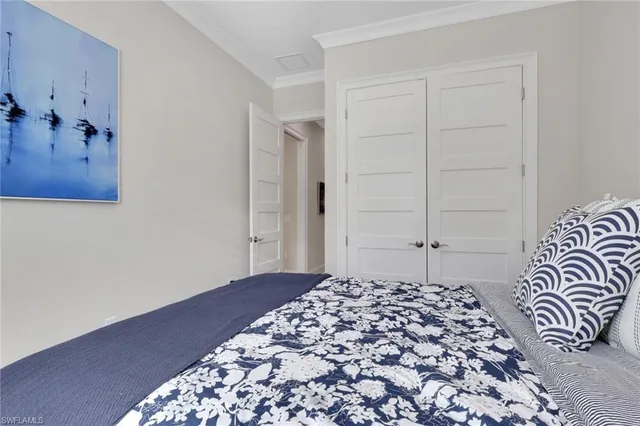 a large bed in a white bedroom