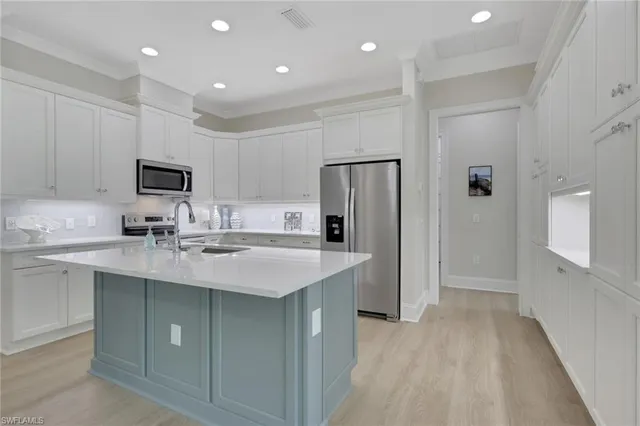 a kitchen with stainless steel appliances granite countertop a refrigerator and a sink