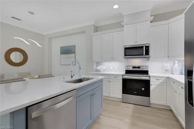 a kitchen with a sink and a stove top oven
