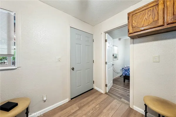 a view of a room with wooden floor cabinet and windows