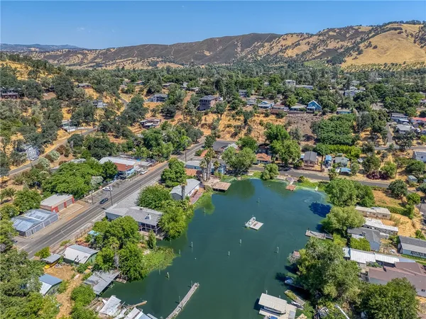 an aerial view of lake residential houses with outdoor space and trees