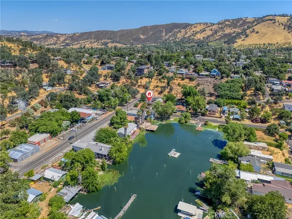 an aerial view of lake residential houses with outdoor space and trees