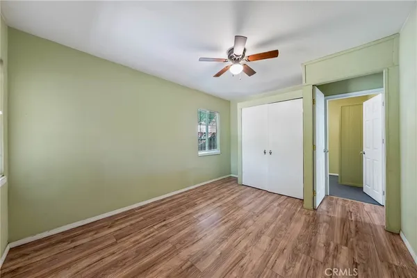 a view of a big room with wooden floor and closet area