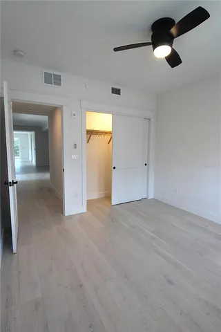 a white toilet sitting next to a bathroom sink and vanity