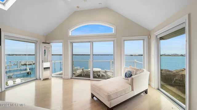 a living room with furniture and floor to ceiling windows
