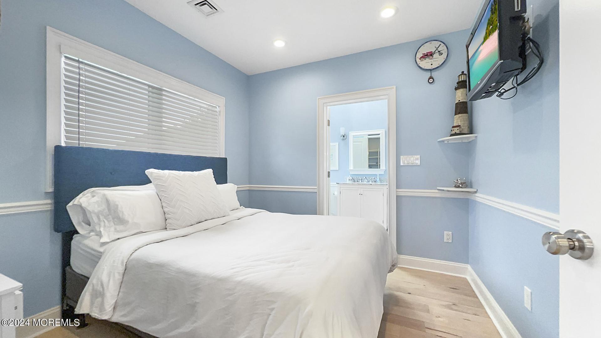 9 Pocano Avenue, Unit A Oceanport, NJ 07757 - Photo 20 of 29 a bed room with a bed and a potted plant