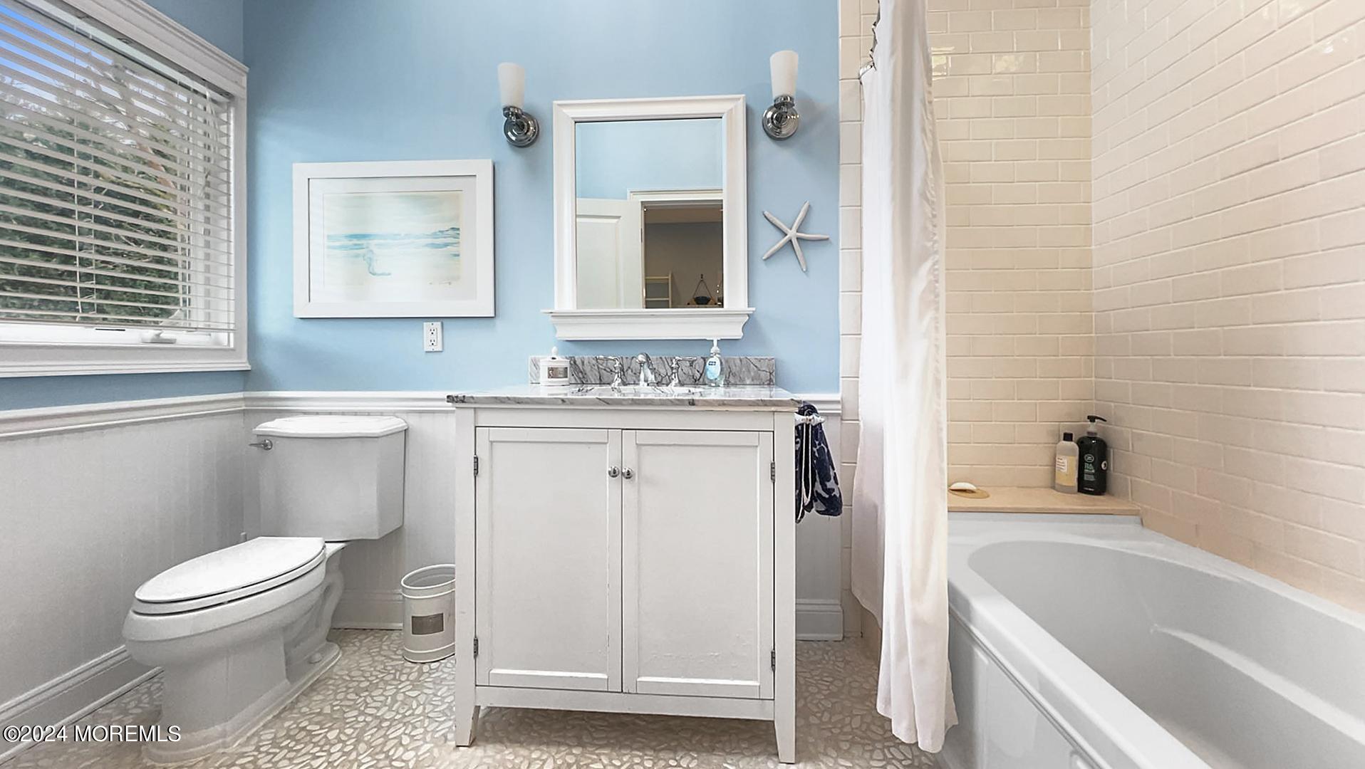 9 Pocano Avenue, Unit A Oceanport, NJ 07757 - Photo 21 of 29 a bathroom with a sink toilet vanity and bathtub