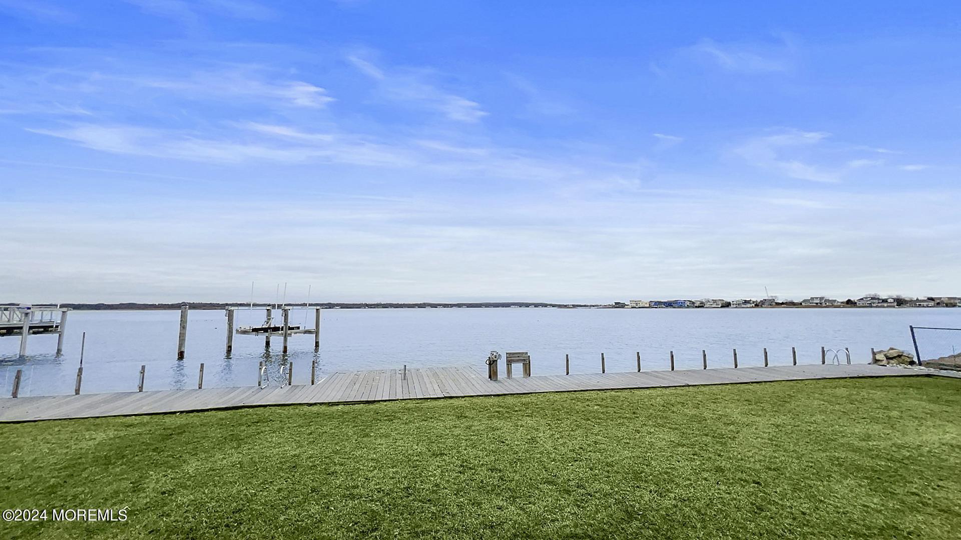 9 Pocano Avenue, Unit A Oceanport, NJ 07757 - Photo 29 of 29 a view of a river and yard with swimming pool and wooden fence