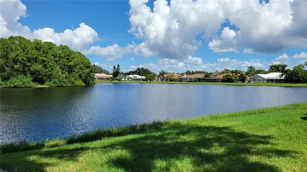 a view of a lake with houses in the back