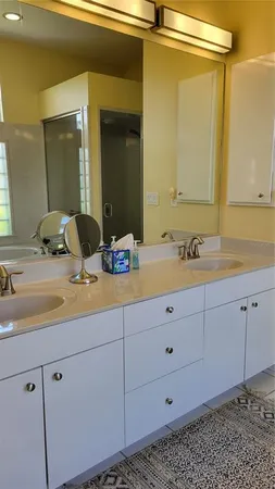 a bathroom with a double vanity sink and mirror