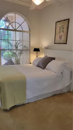 a bedroom with a bed and a painting on the wall