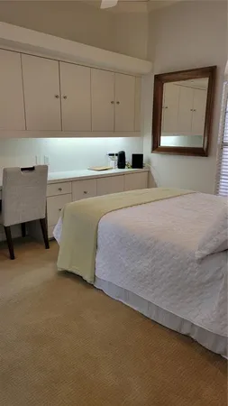 a bedroom with a bed and a night stand