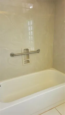 a bathroom with a shower and a bath tub