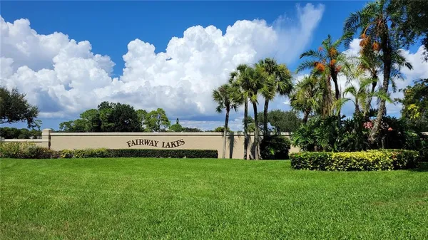a view of yard with swimming pool and green space