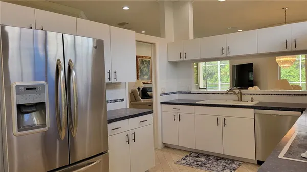 a kitchen with stainless steel appliances a refrigerator sink and cabinets