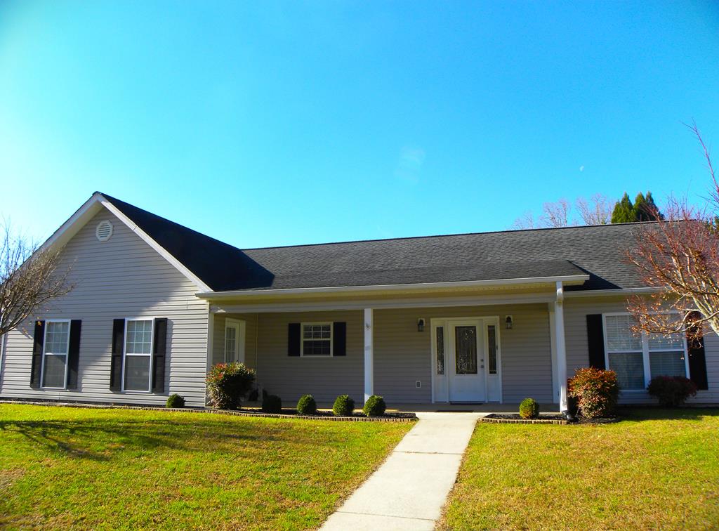 a view of a house with swimming pool and a yard