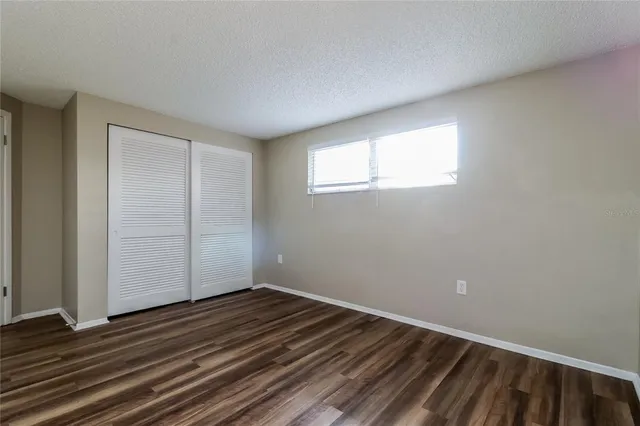 a view of a room with wooden floor