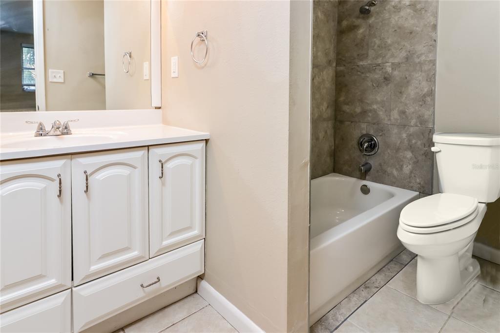 8653 Sabal Way Port Richey, FL 34668 - Photo 9 of 16 a bathroom with a sink a toilet and shower