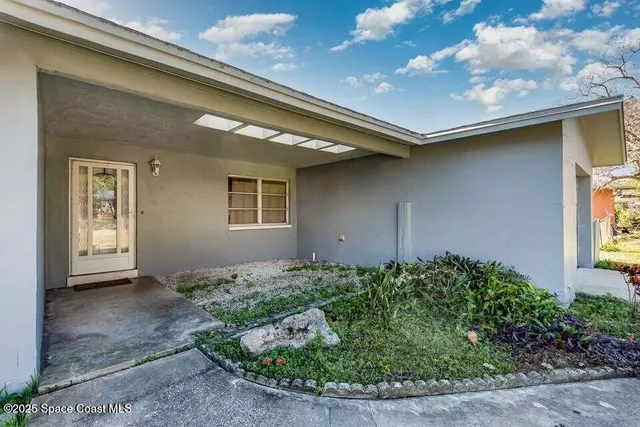 a backyard of a house with outdoor seating