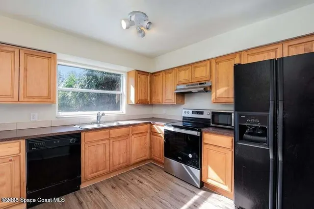 a kitchen with a sink stove and refrigerator