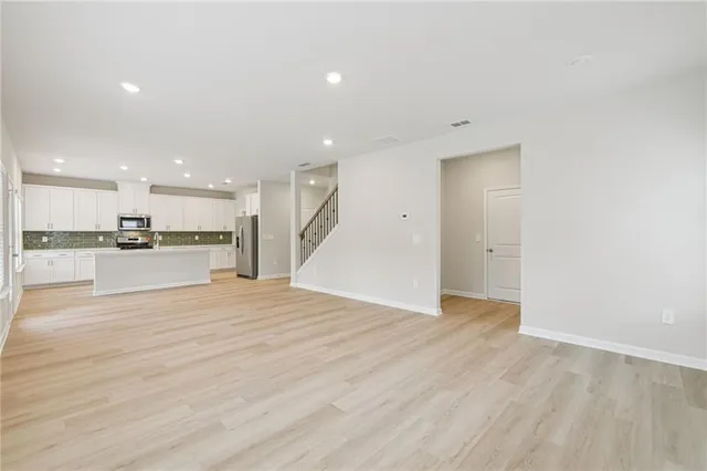 a view of kitchen with kitchen island and wooden floor