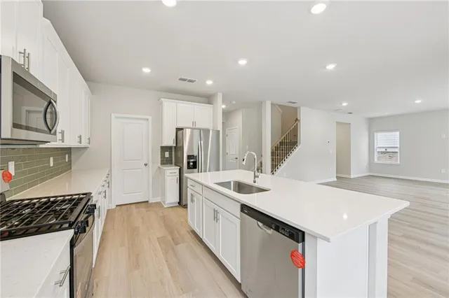 a kitchen with a sink stove and refrigerator