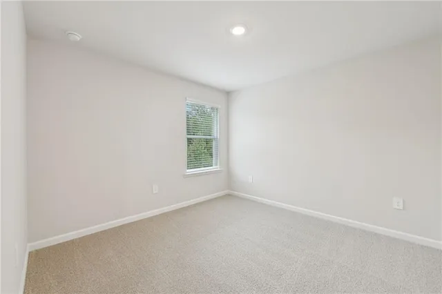 a view of an empty room and a window