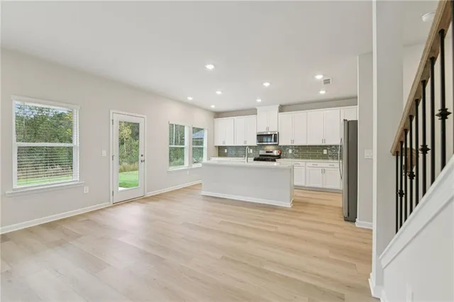a view of kitchen with wooden floor and windows