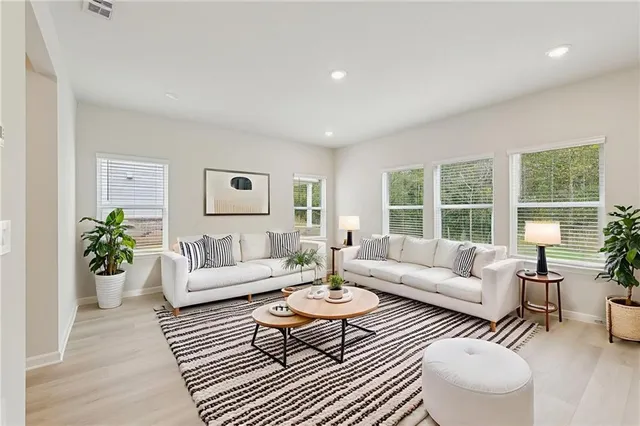 a living room with furniture and a large window