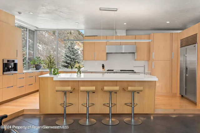 a kitchen with stainless steel appliances kitchen island granite countertop a sink and cabinets