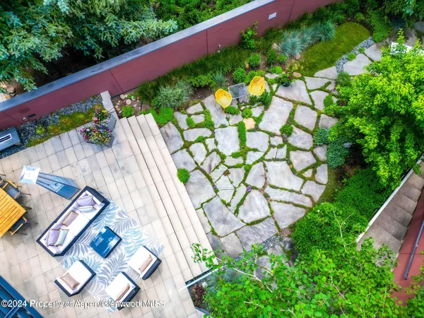 a view of yard with potted plants
