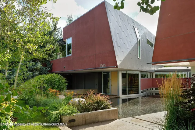 a house with lots of trees in front of it