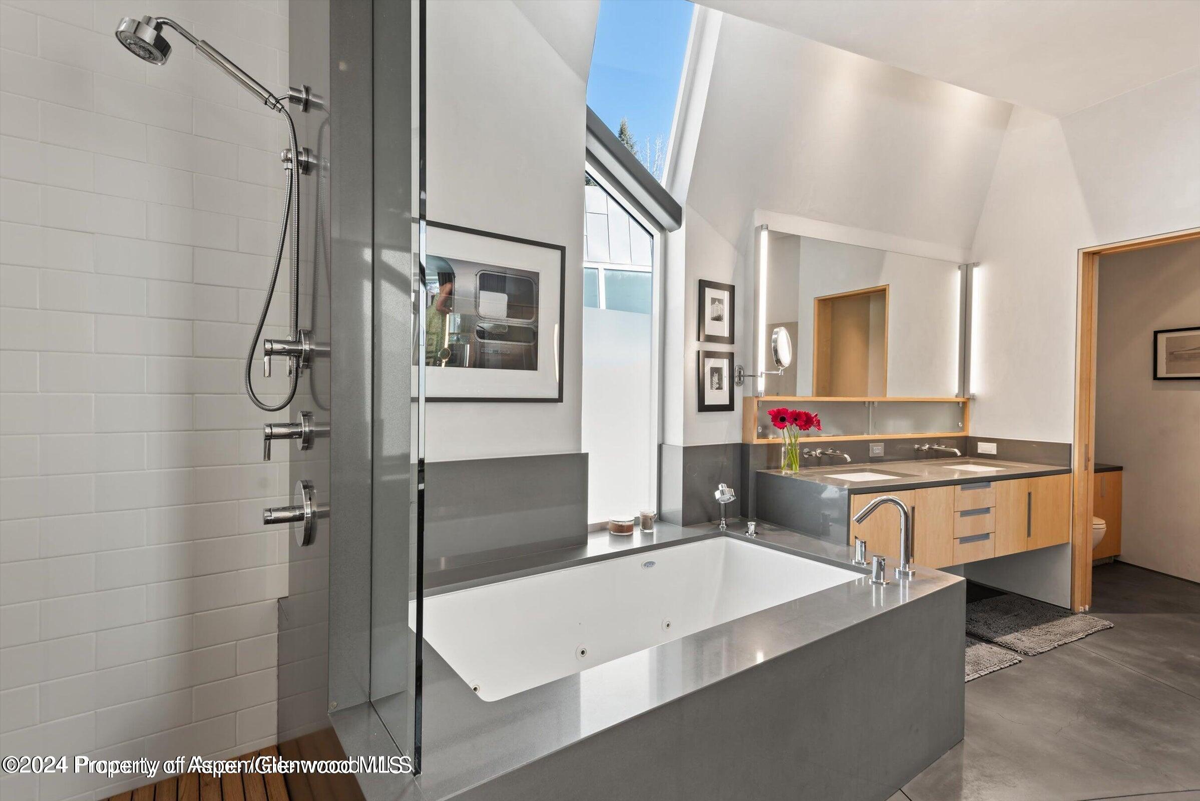 1015 Cemetery Lane Aspen, CO 81611 - Photo 22 of 46 a large bathroom with a tub a sink and a mirror