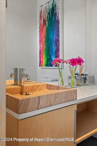 a bedroom with a large bed and a flat tv screen on dresser