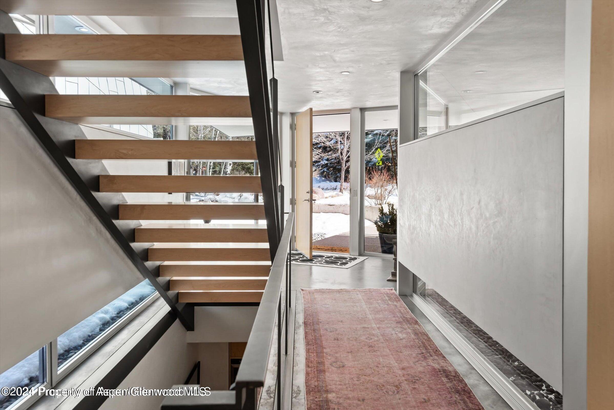 1015 Cemetery Lane Aspen, CO 81611 - Photo 25 of 46 a view of an empty room with wooden floor and windows