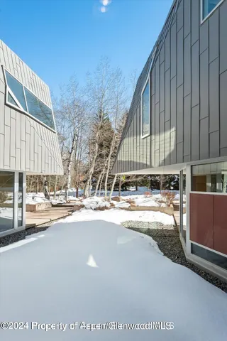 a bedroom with furniture and a flat screen tv