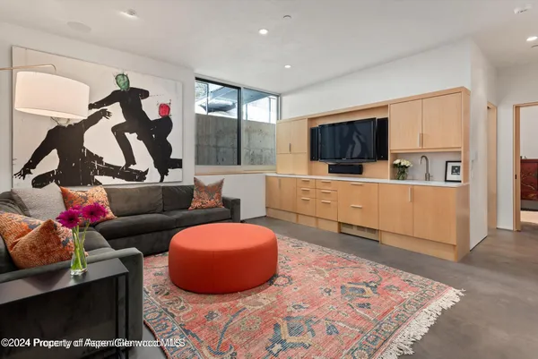 a living room with furniture and a floor to ceiling window