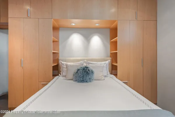a bedroom with a large bed and a large window